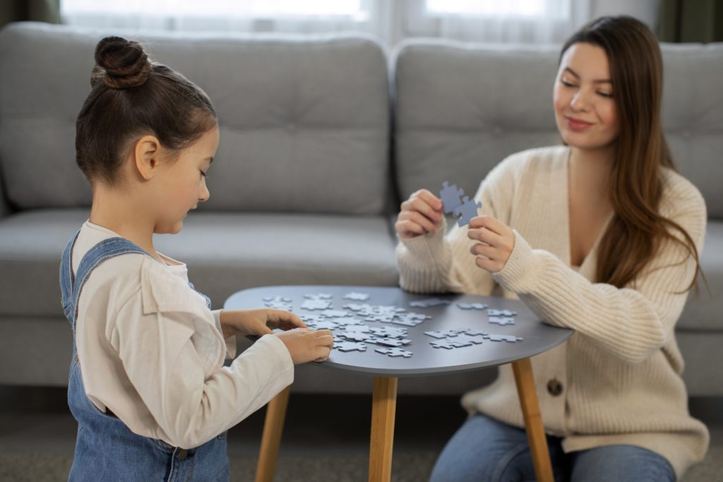 ABA therapist from Soaring high playing game with a girl