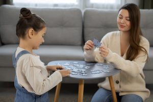 ABA therapist from Soaring high playing game with a girl